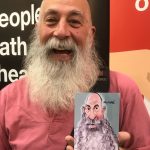 Man with gray beard and printed caricature